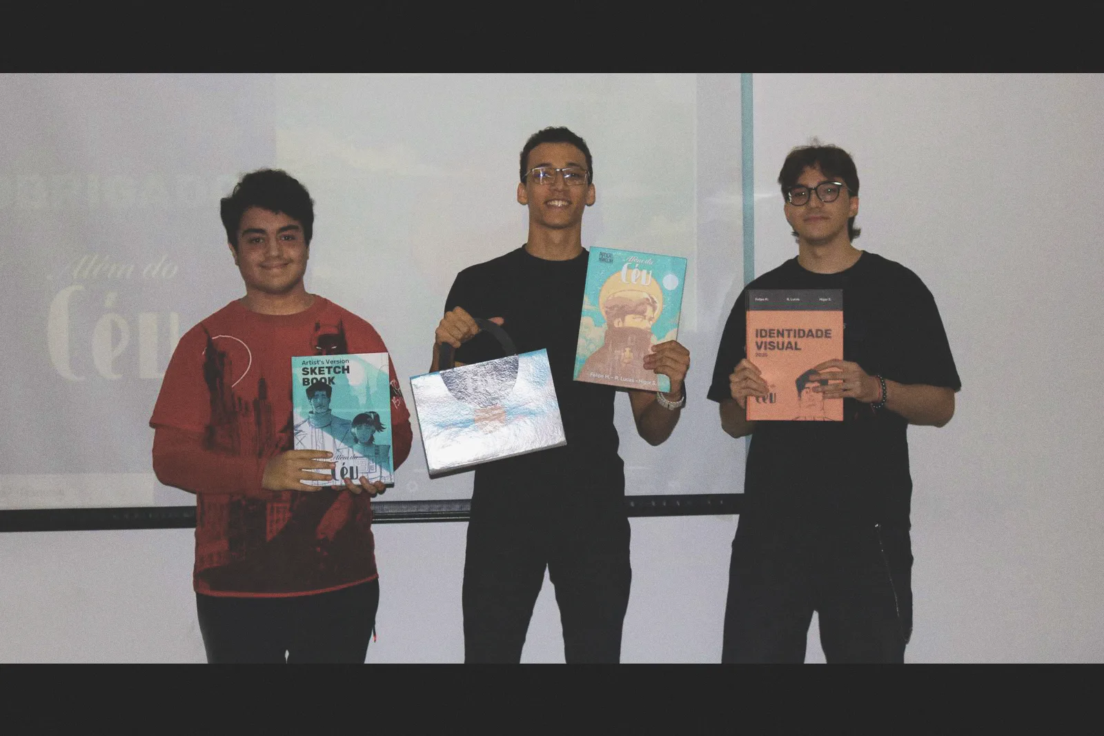Beyond the Sky team holding the final publications and custom box