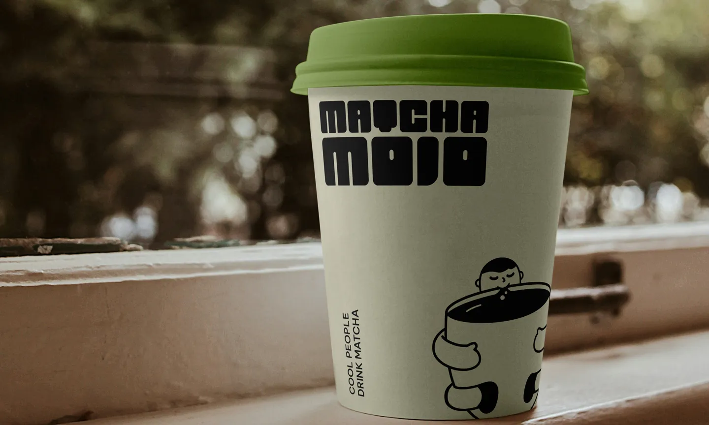 Matcha Mojo illustrated hot cup with green lid